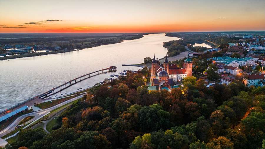 Aerial view of Tumskie Hill cathedral and the Vistula at Płock at sunset