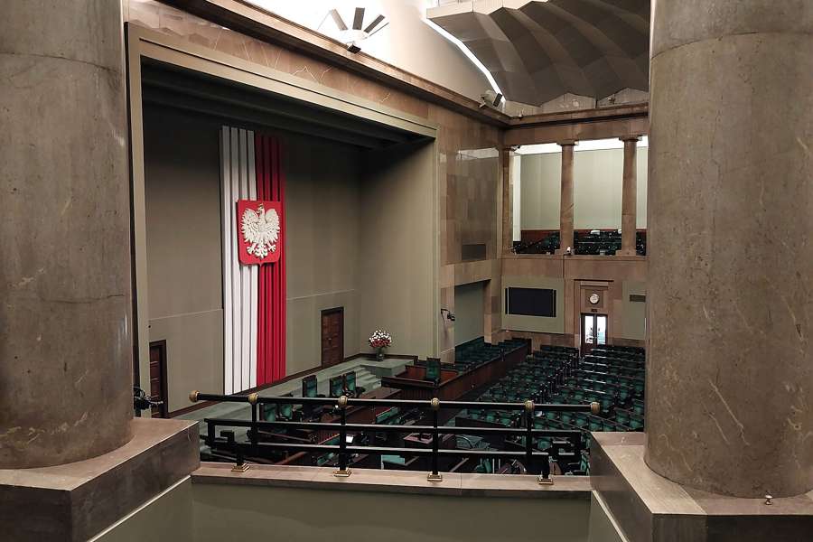 The Sejm debating chamber in Warsaw, empty, with the Polish eagle over the podium