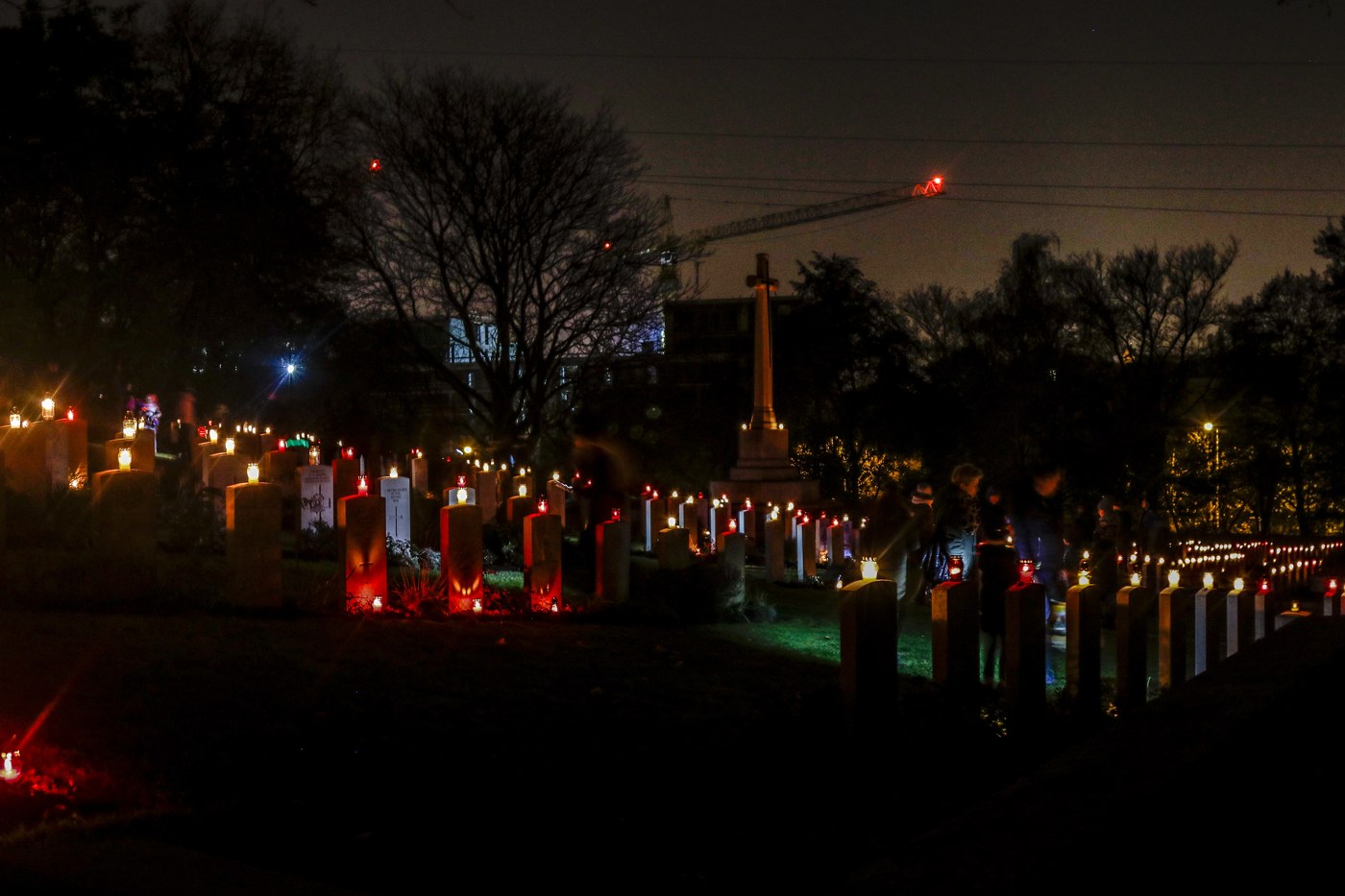 Historical view of candlelit graves at the Cemetery of Polish Heroes in Poznań
