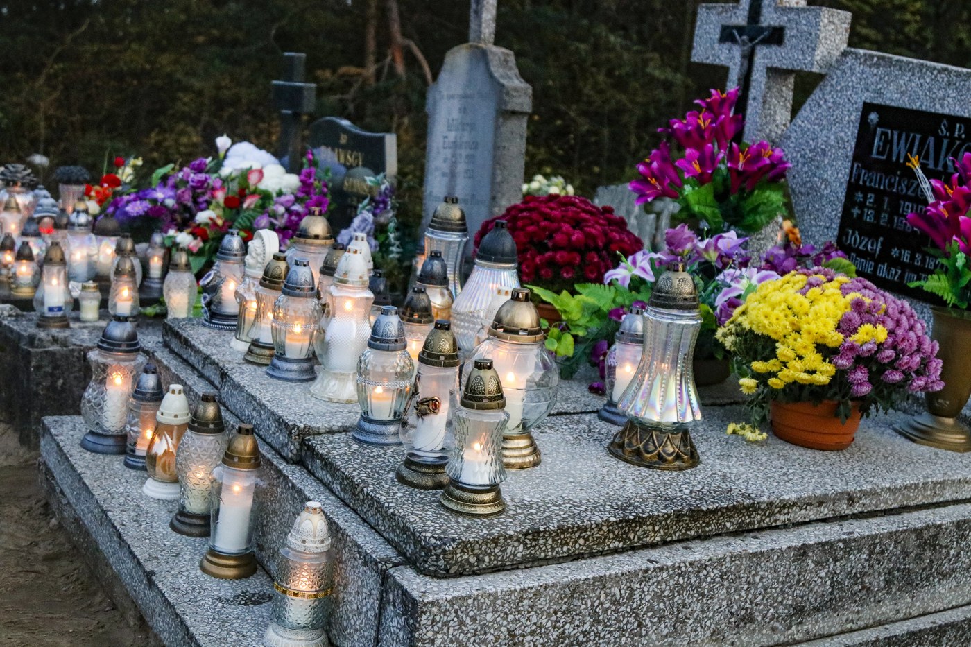 Historical view of candles and flowers on graves at Powidz Cemetery in Poland