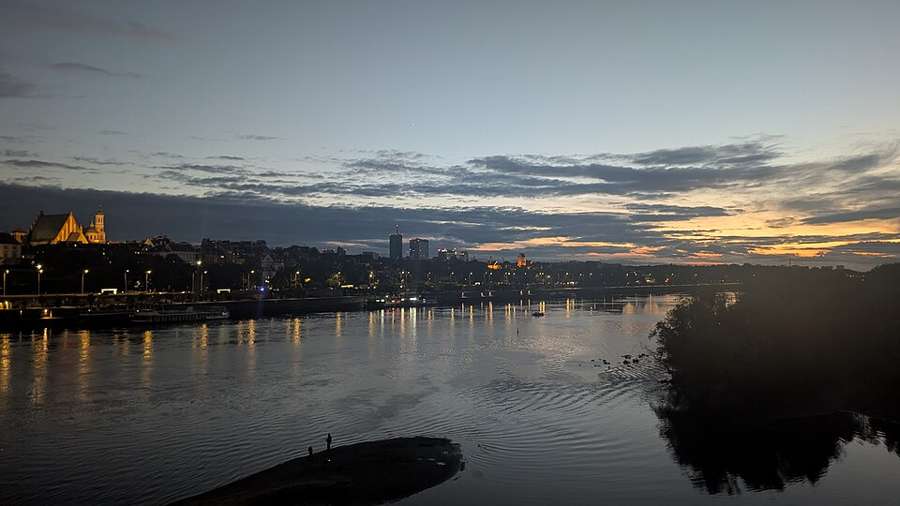 Warsaw Old Town skyline and the Vistula river at sunset
