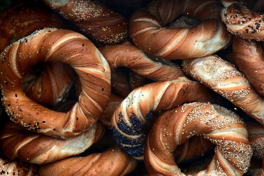 A pile of obwarzanki, Krakow's ring-shaped bread, with sesame and poppy seed toppings