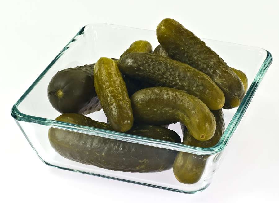 Polish-style fermented cucumbers, ogorki kiszone, in a glass bowl