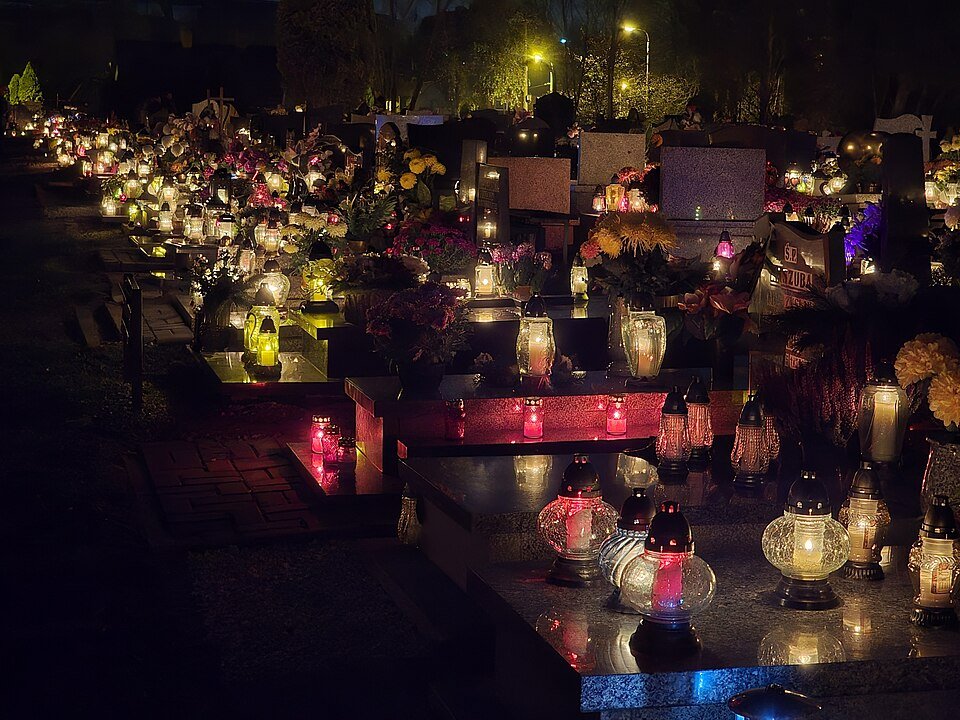 Graves decorated with znicze candles on All Saints' Day in Poland