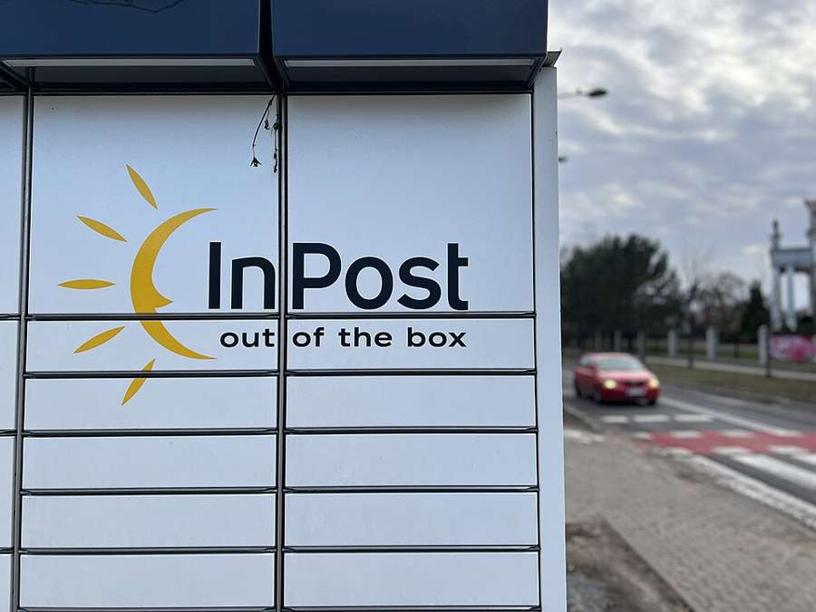 An InPost Paczkomat parcel locker close-up showing the InPost logo and compartment doors