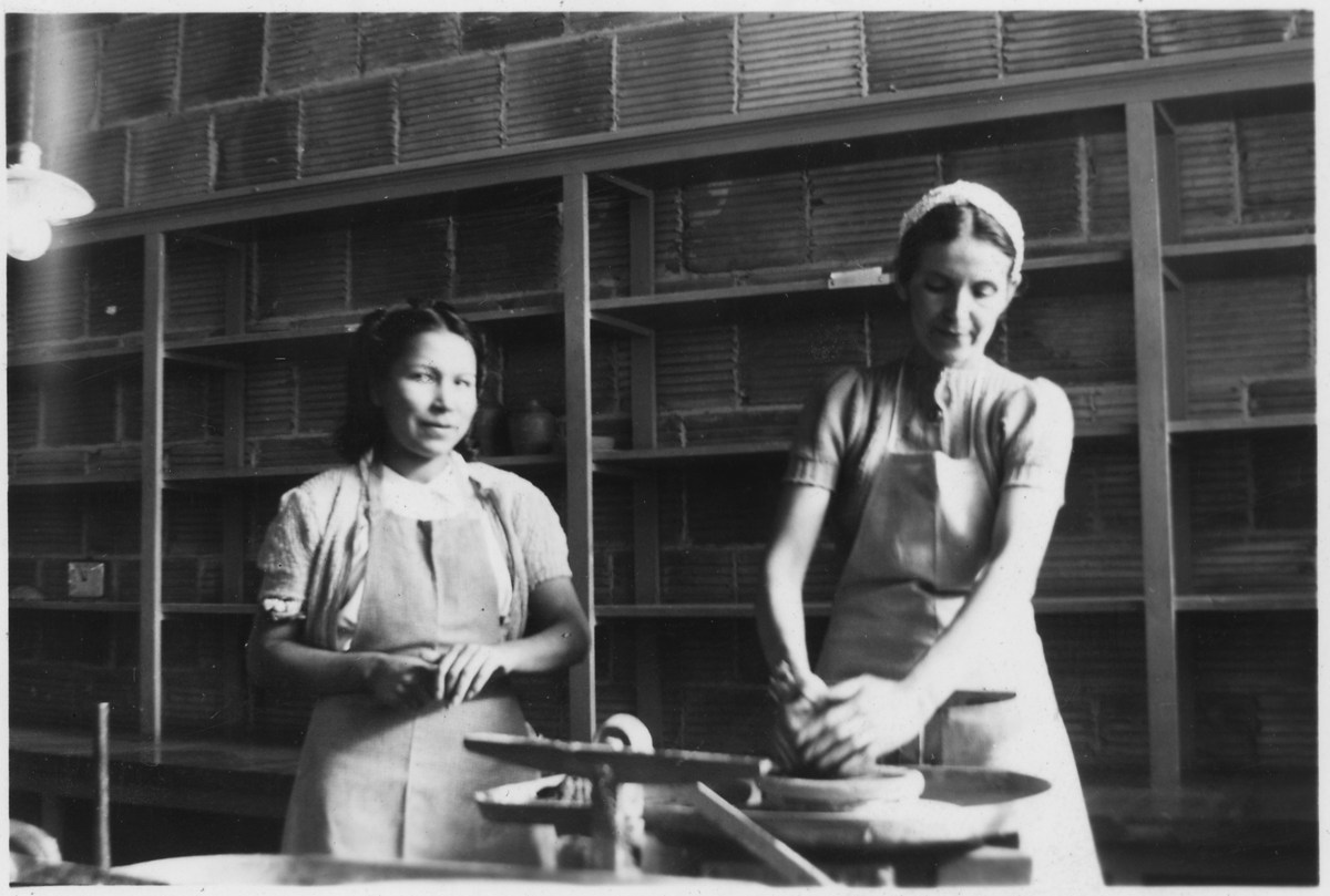 Archival photograph of women working at pottery wheels from the U.S. National Archives
