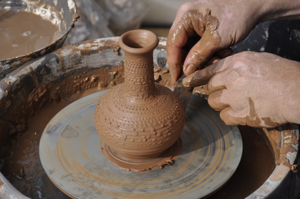 Historical close view of work at a pottery wheel in July 2015