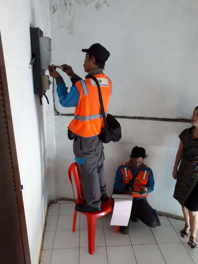 Electricians fixing an electricity meter