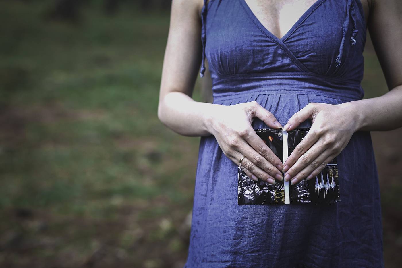 Pregnant woman holding an ultrasound printout