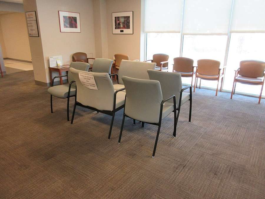 A bright, empty waiting room in a modern private medical clinic