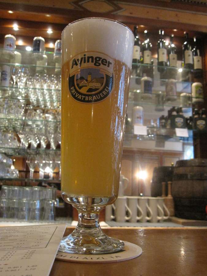 A fresh beer glass on a pub counter