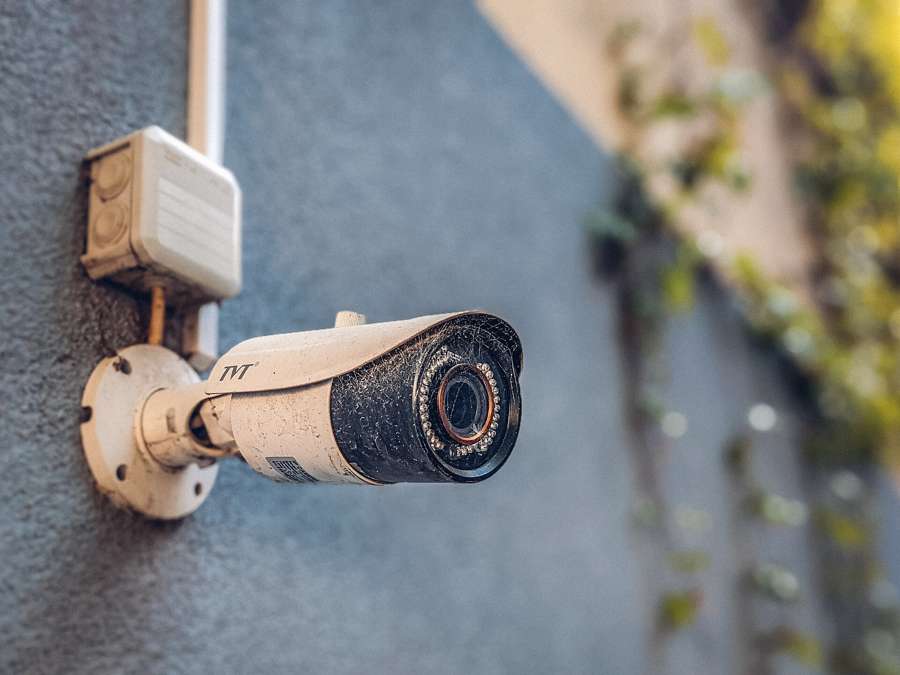 Surveillance camera mounted on a building wall in a pedestrian area
