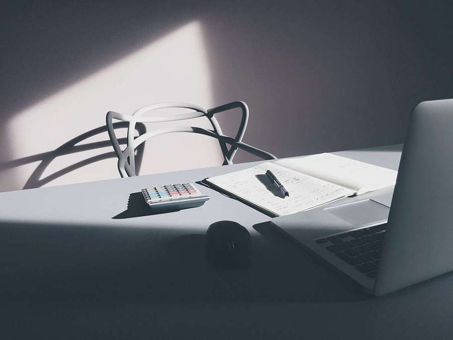 A laptop and calculator on a desk