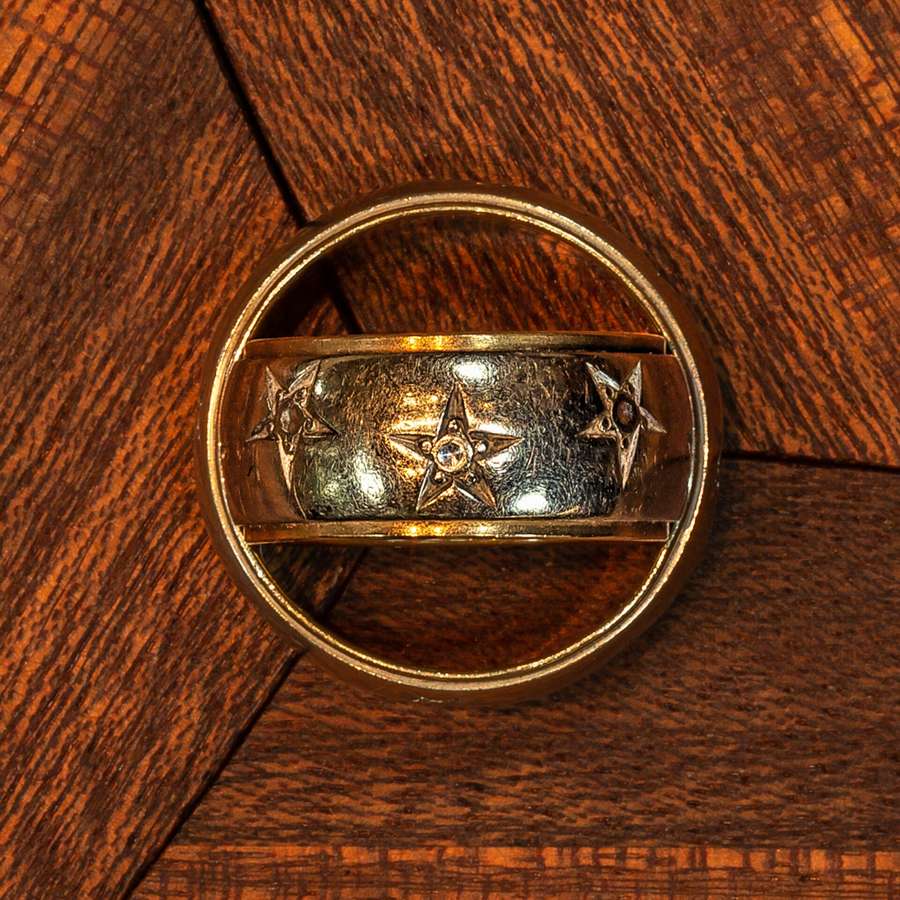 Two gold wedding rings on a wooden table