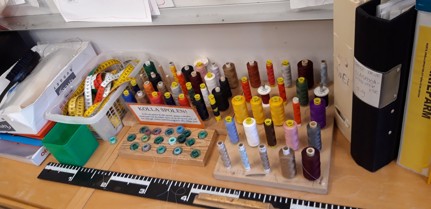 Threads, bobbins and measuring tools on a handicrafts-classroom worktable in Sundbyberg, Sweden, March 2019