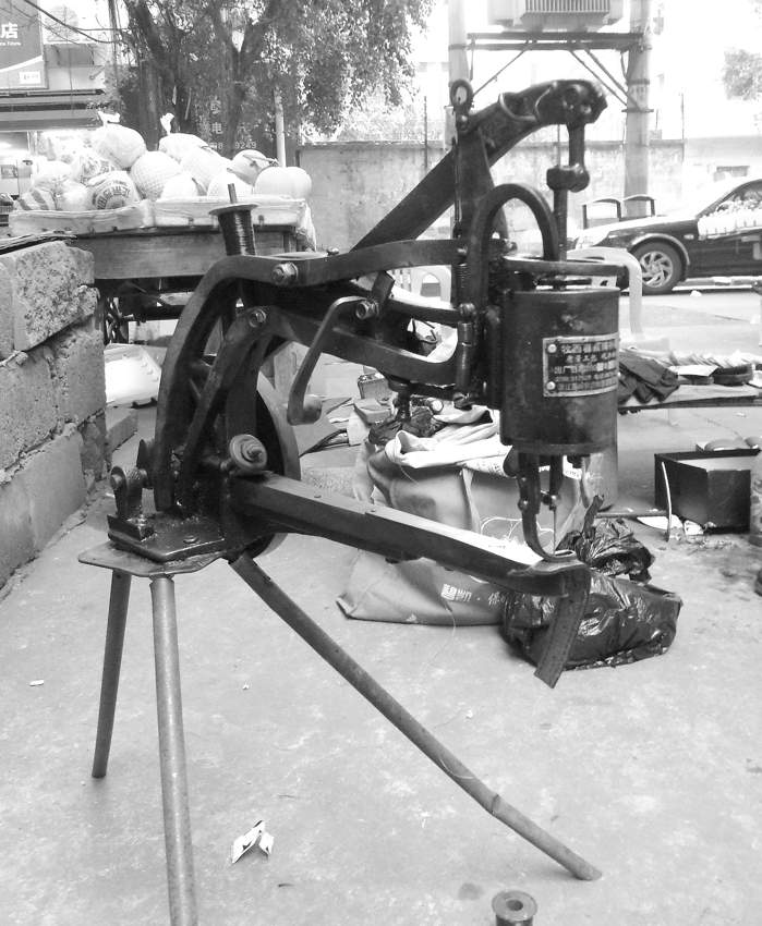 Hand-cranked shoe and bag sewing machine photographed in Haikou, China