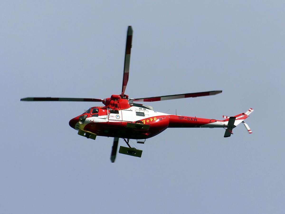 A TOPR rescue helicopter in the air over the Tatra Mountains