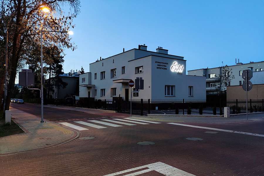A white apartment block and a street in Stalowa Wola