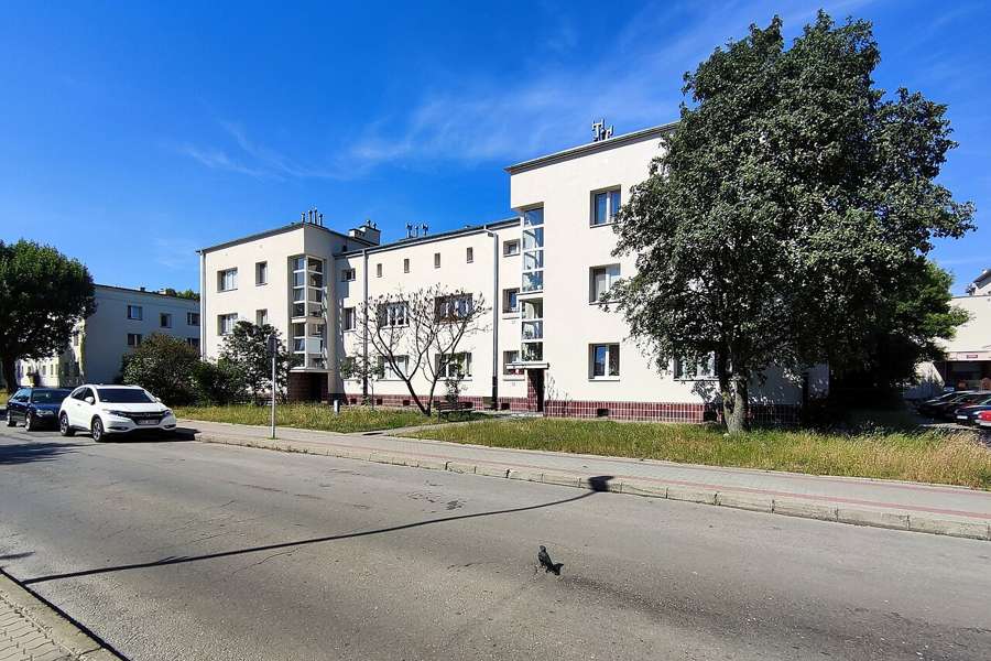 Street and residential buildings in Stalowa Wola under a blue sky