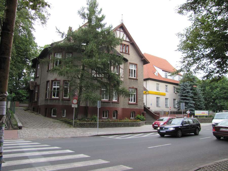 Street with historic houses and a pedestrian crossing in Stargard