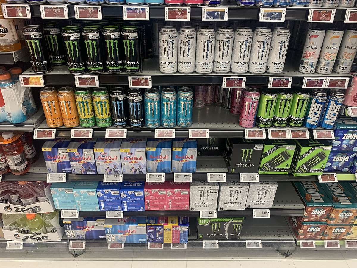 Soft drinks and energy drinks on a shop shelf, illustrative