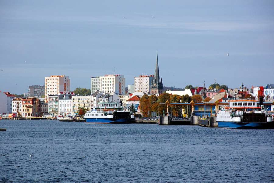 Świnoujście waterfront seen from the ferry with a church spire