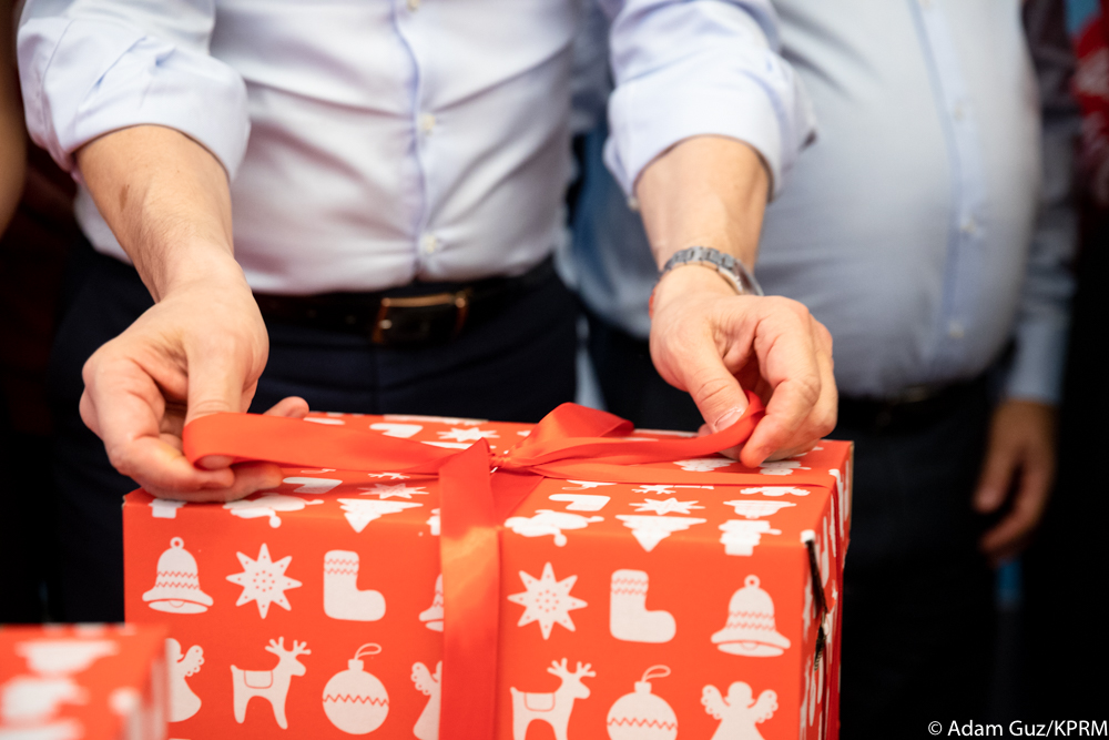 Tying the ribbon on a red Szlachetna Paczka parcel box