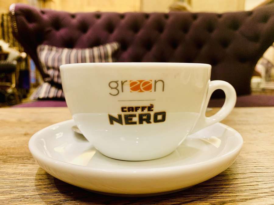 A coffee cup on a wooden table in a Warsaw cafe