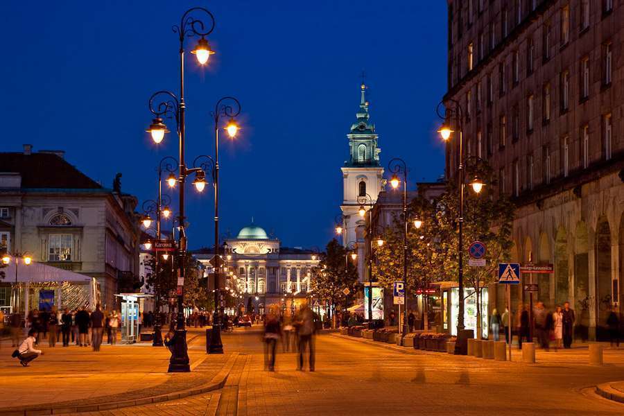 Krakowskie Przedmiescie street in Warsaw at night, lit by lamps - a quiet setting for an honest conversation