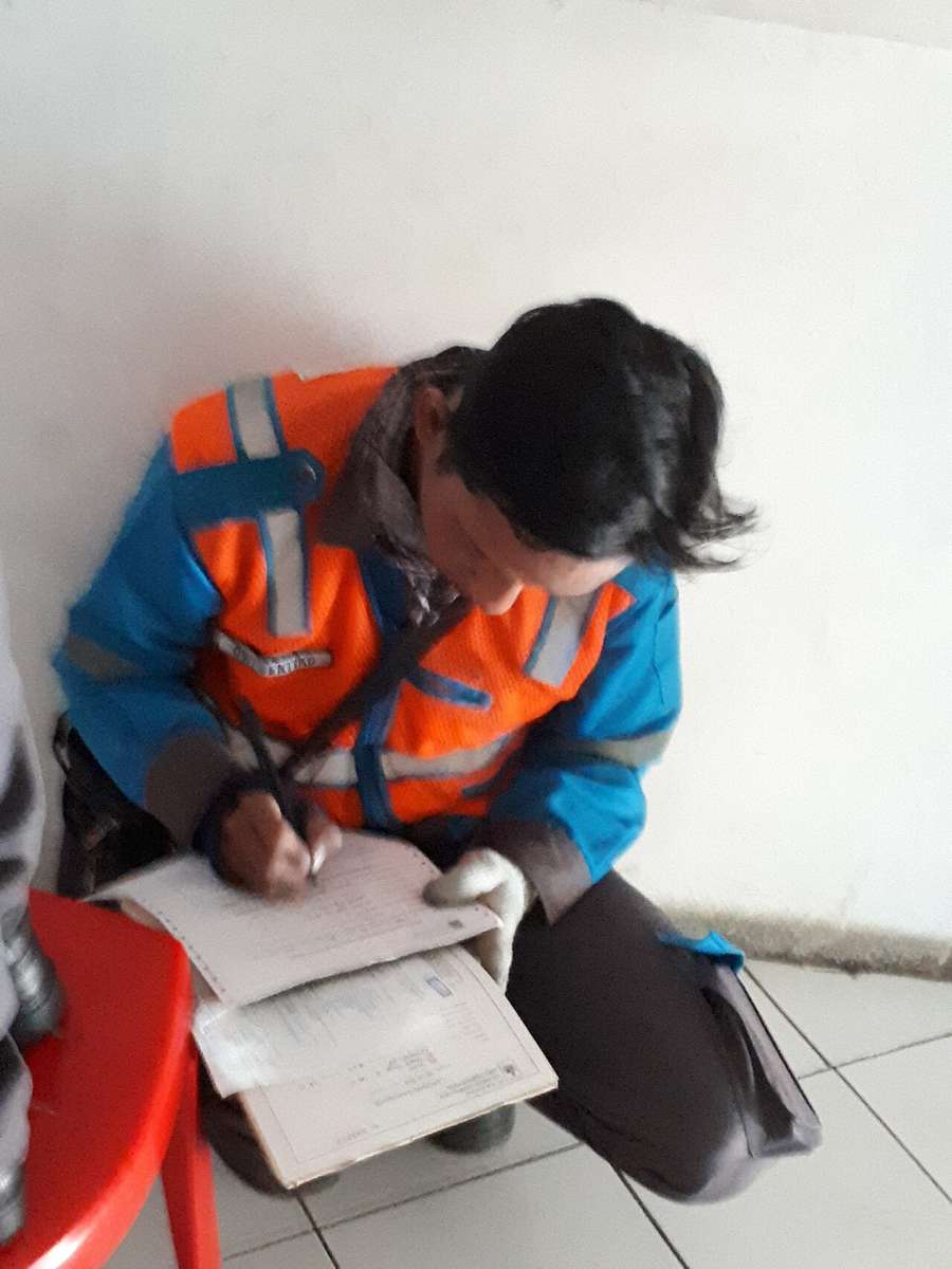 A utility worker fixing an electricity meter