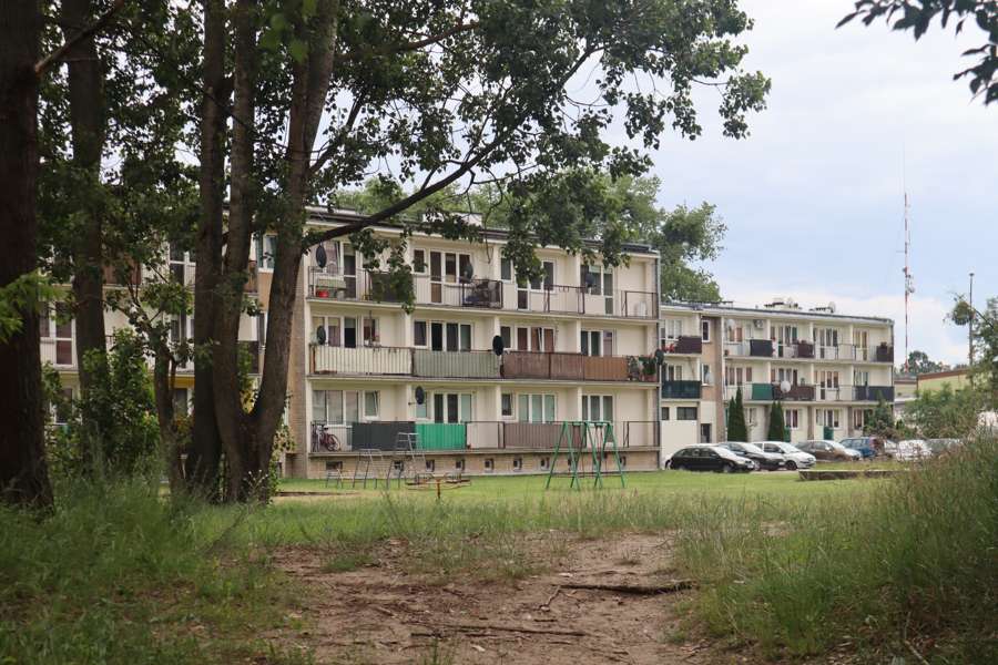 Apartment blocks on a green Warsaw housing estate with a playground