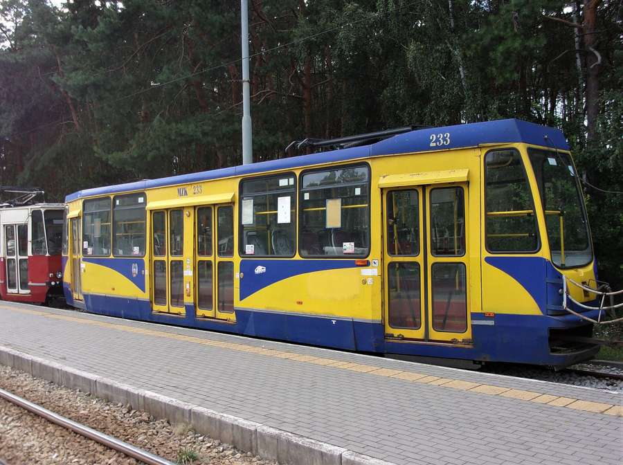 A yellow and blue MZK tram at the Olimpijska tram loop in Torun, 2021