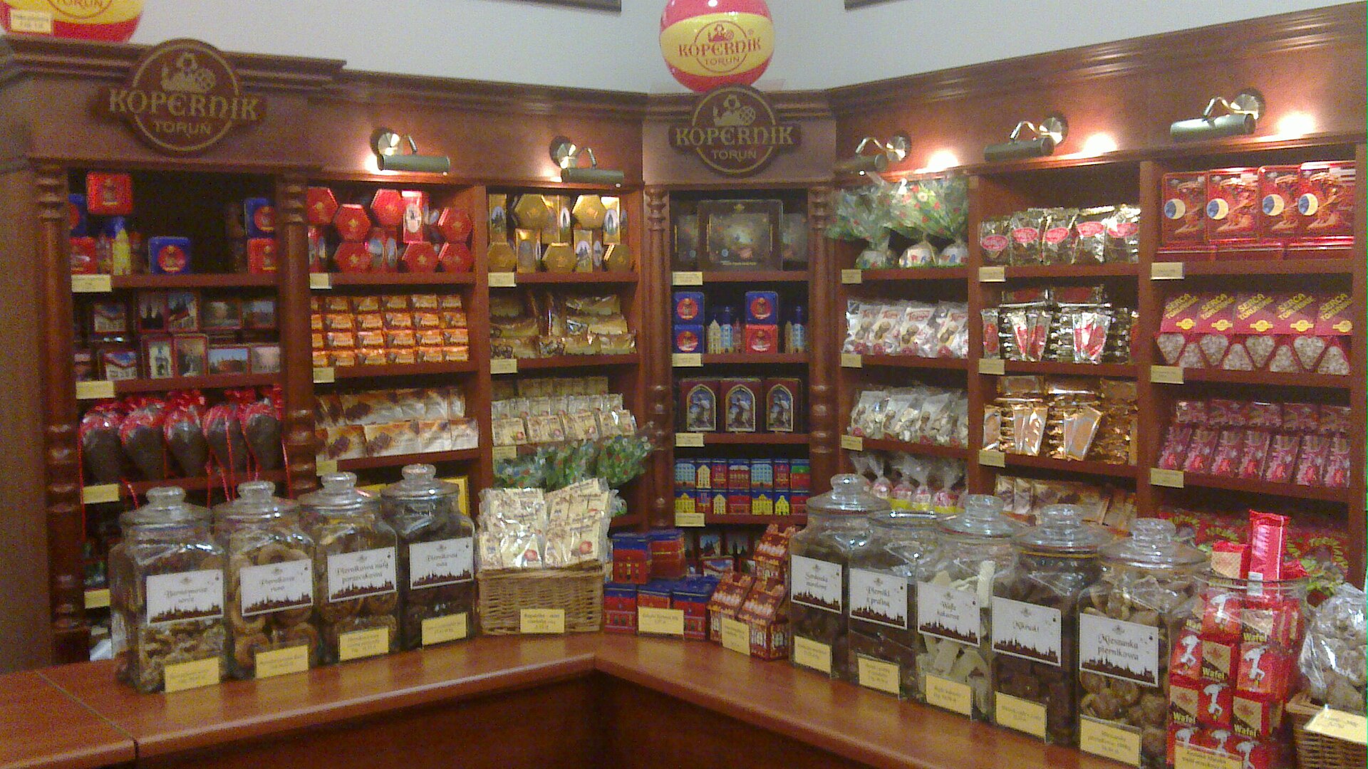 Inside a Kopernik gingerbread shop in Toruń, with shelves of pierniki in tins and jars