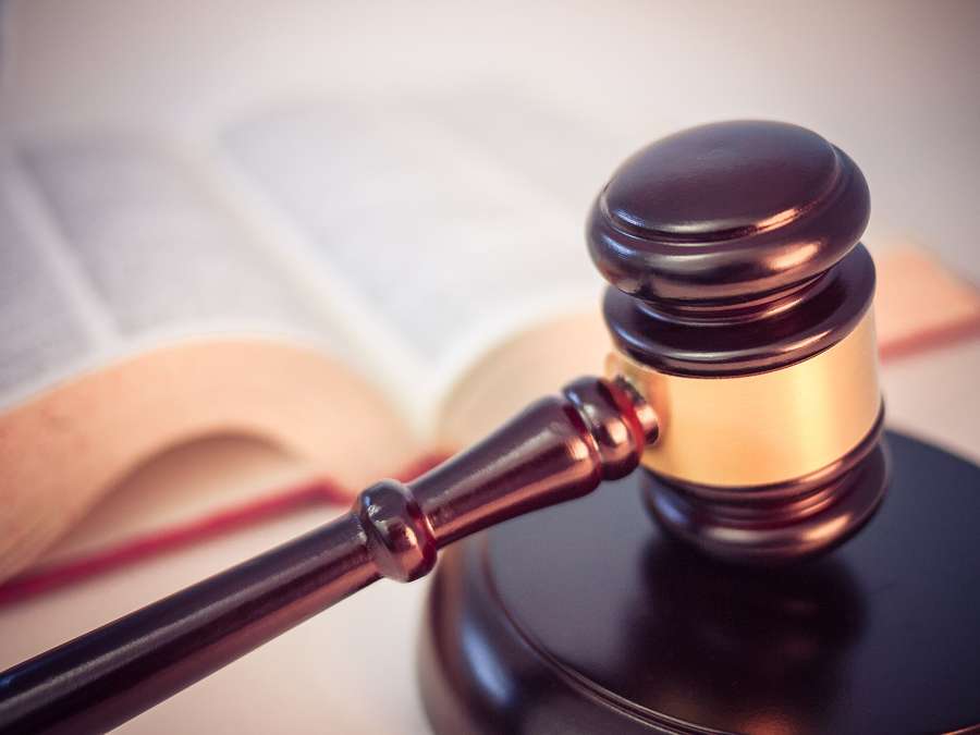 A gavel resting on an open law book