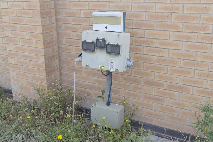 An electricity connection box on a building wall - ask to see a few past bills before signing a lease