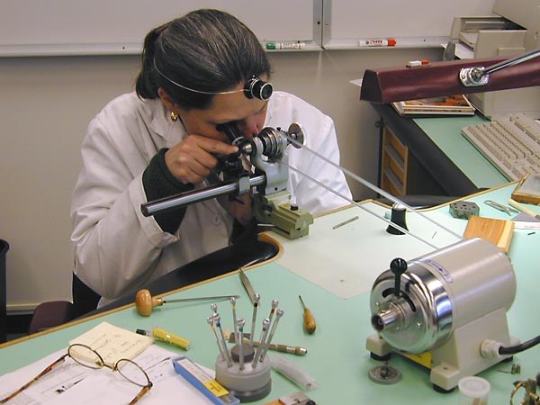 Watchmaker working at a bench, illustrative image from outside Poland