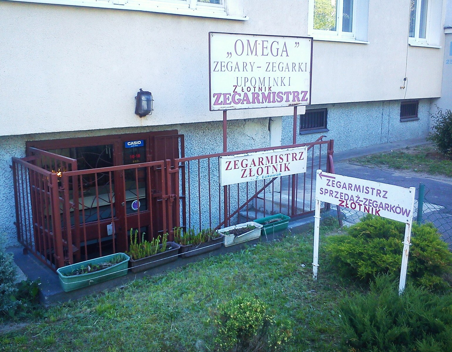 Watchmaker shopfront with Polish zegarmistrz signs in Poznan, illustrative photograph