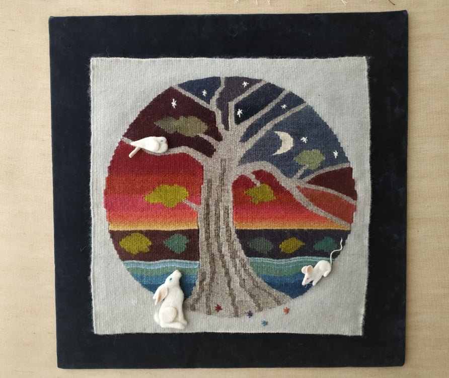 A tapestry with an abstract tree and colourful circular background from SEN Heritage Looms