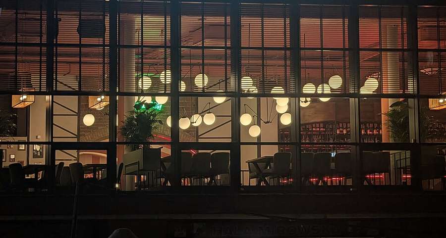 Café windows glowing at night in Hala Mirowska, Warsaw