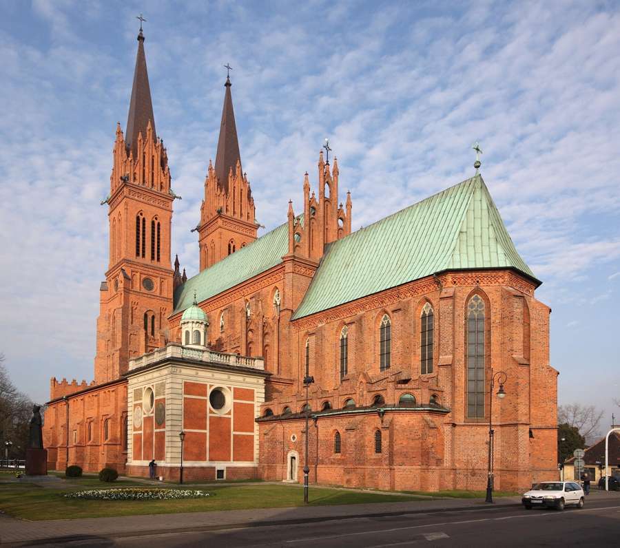 The brick Gothic cathedral of Włocławek with its copper-green roof and twin spires
