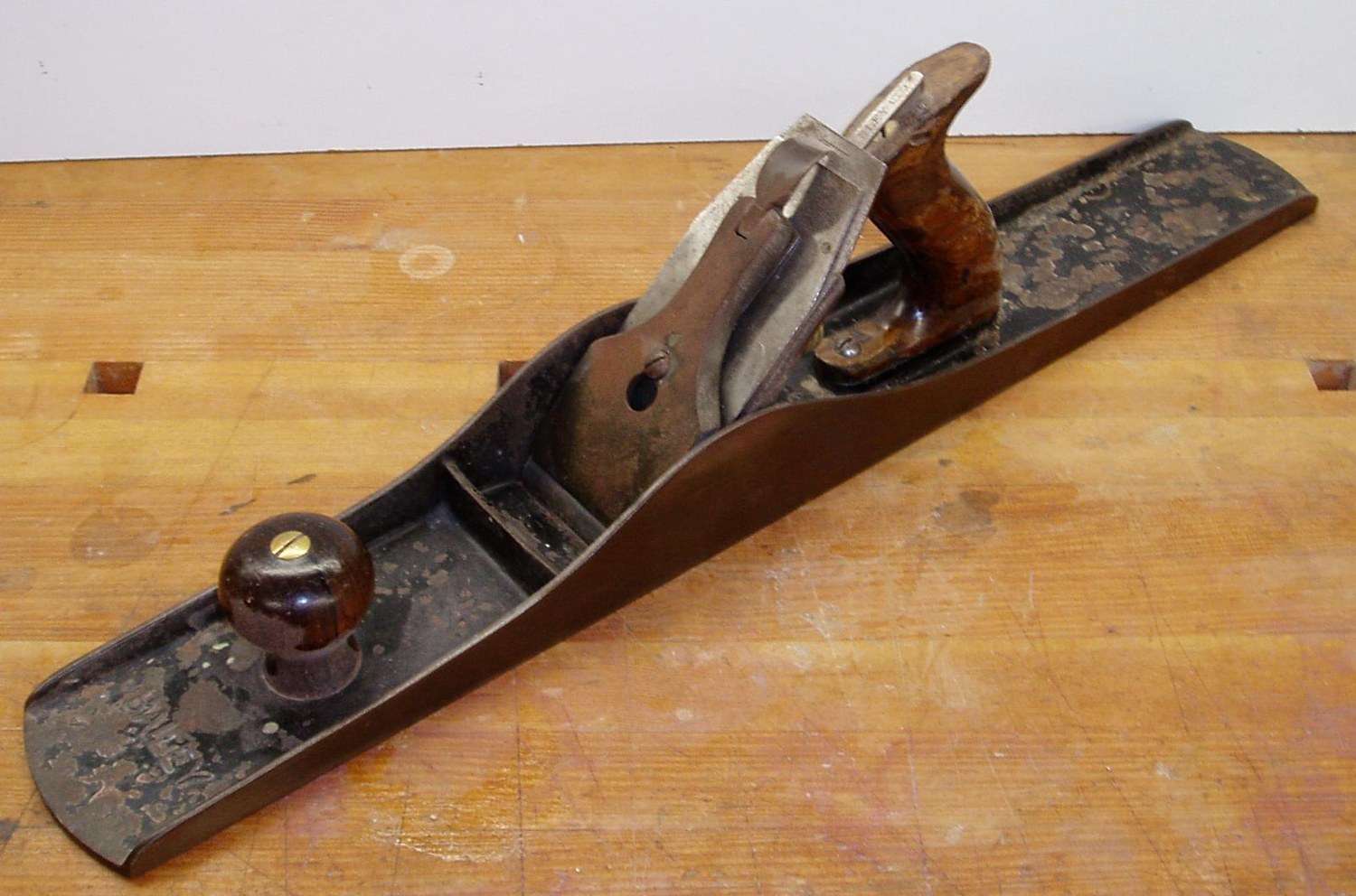 Stanley No7C jointer plane resting on a wooden workbench
