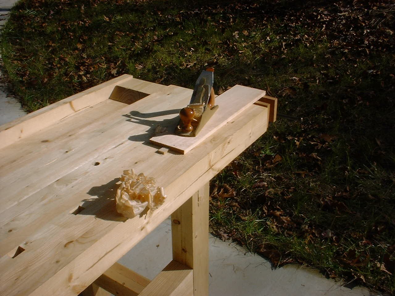 Wooden workbench with a bench dog securing a board, photographed in November 2000