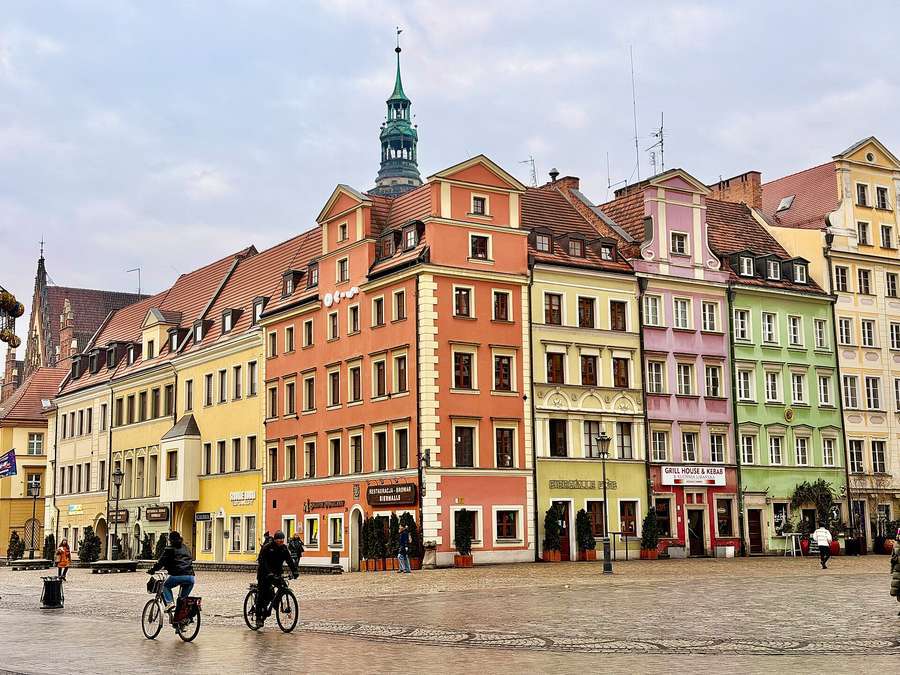 Colourful townhouses on Wrocław's Rynek with the Old Town Hall tower