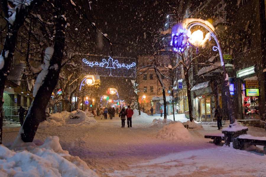 Krupowki street in Zakopane in falling snow with Christmas illuminations, March 2012