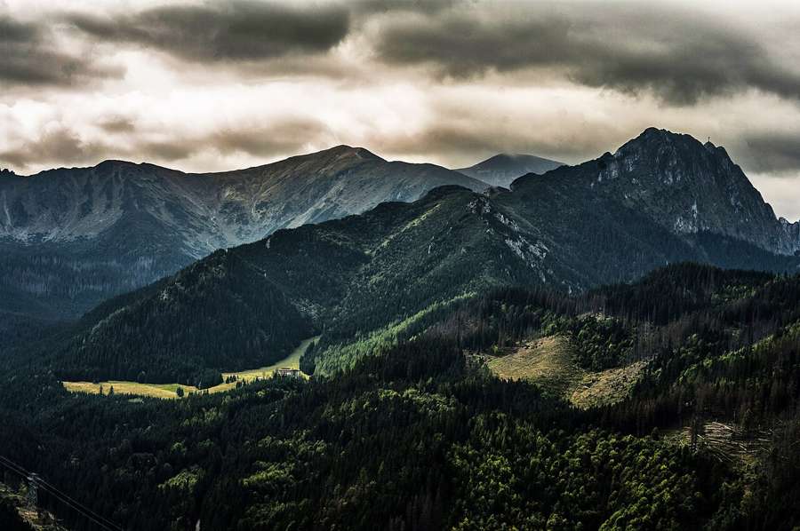 The Giewont massif and forested slopes near Zakopane under heavy clouds