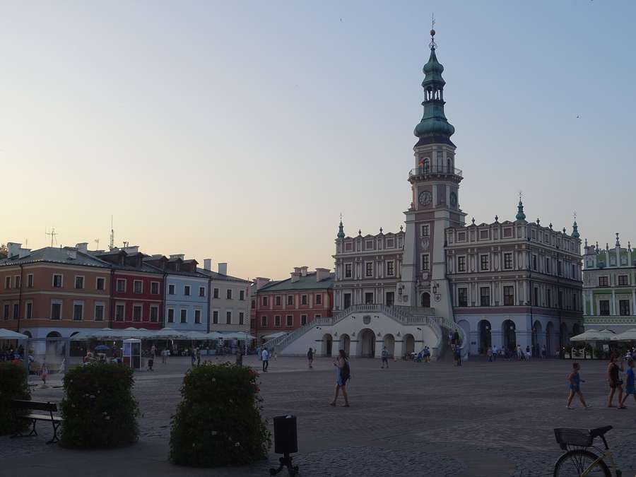 Zamosc Great Market Square with the town hall tower and fan-shaped staircase at dusk