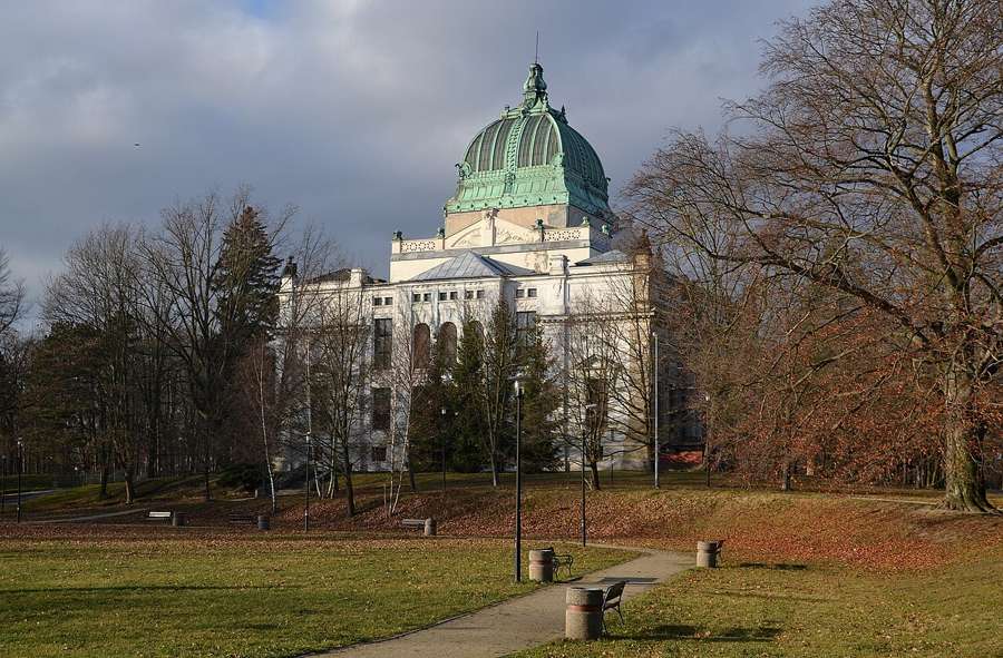 Culture House with a green copper dome in Zgorzelec surrounded by autumn trees